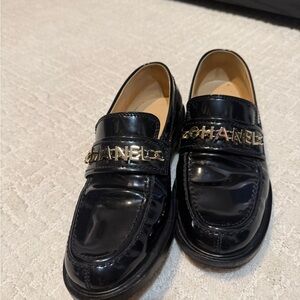 CHANEL Glossy Black Loafers with Gold Accents